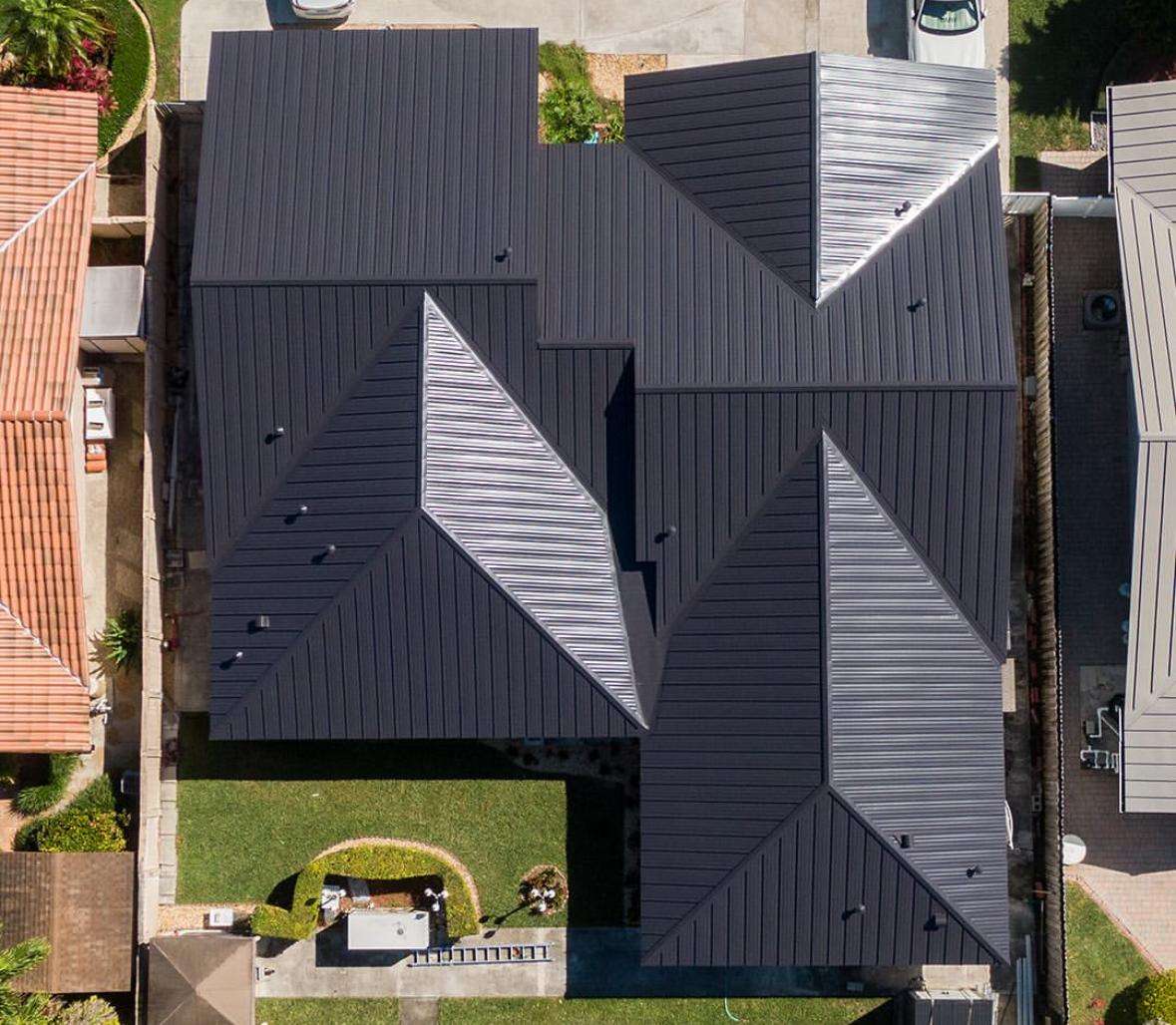 Black standing seam metal roof installed by California Building Professionals